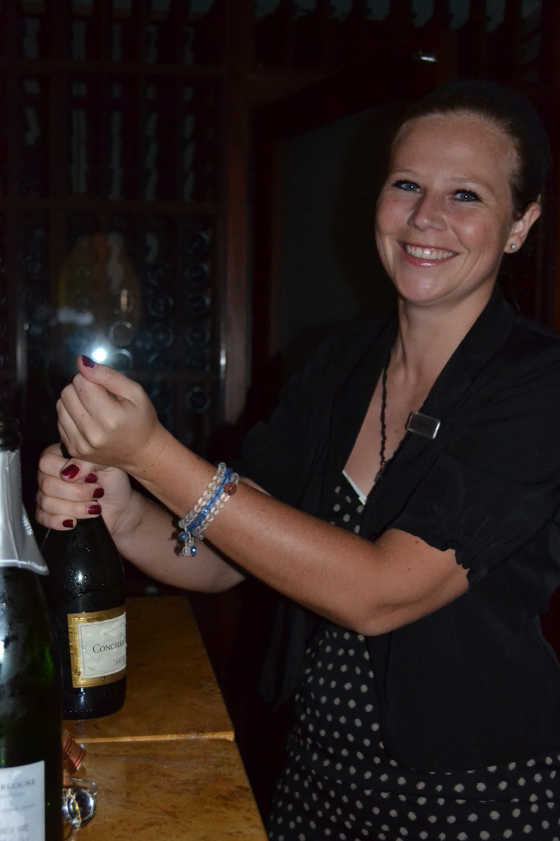 Ruth's Chris management Mariette Wentink popping the champagne.JPG