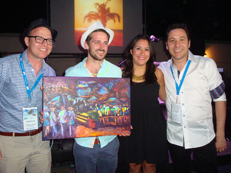 Winner Harry Rowe holding his painting by Elvis Tromp flanked by ATA staff and his winning picture in background.jpeg