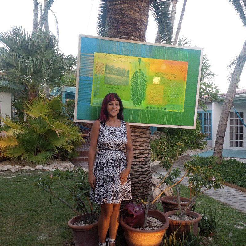 Elisa Lejuez posing with her artwork.jpeg